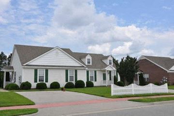 Wilson apartment for rent - a white house with green shutters and a white fence