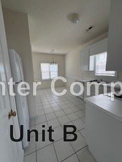 Wilson apartment for rent - A kitchen with white cabinets and a white door.