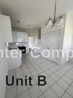 Wilson apartment for rent - A kitchen with white cabinets and a white door.
