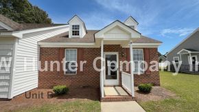 Wilson apartment for rent - A brick house with a white door and windows is for sale.