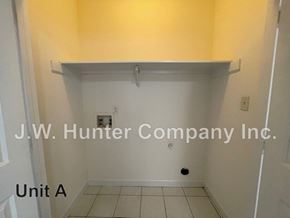 Wilson apartment for rent - A white wall with a shelf and J.W. Hunter Company Inc. written on it.