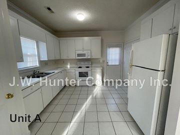 Wilson apartment for rent - A kitchen with white cabinets and appliances is labeled as Unit A.