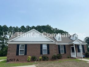 Wilson apartment for rent - A brick house with the words Unit A on the front.