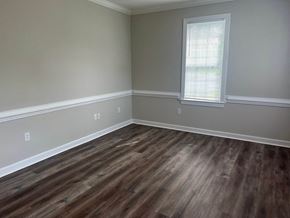 Wilson apartment for rent - A room with a window and wooden flooring.