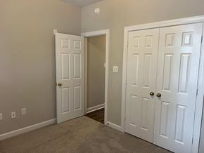 Wilson apartment for rent - A room with two white doors, one of which is open.