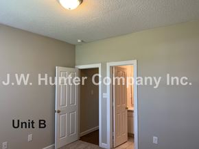 Wilson apartment for rent - A room with a door and a wall with J.W. Hunter Company Inc. written on it.