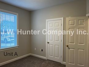 Wilson apartment for rent - A room with a window and a door with the text LW Hunter Company Inc. Unit A.