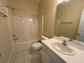 Wilson apartment for rent - A white toilet and sink in a bathroom.