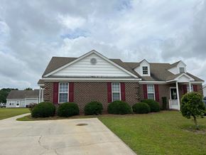 Wilson apartment for rent - A house with a red front door and red shutters.