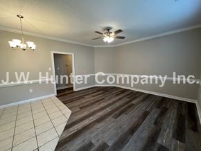 Wilson apartment for rent - A room with wooden flooring and a ceiling fan.