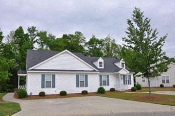 Rocky Mount apartment for rent - a white house with blue shutters and a driveway