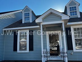 Wilson apartment for rent - A blue house with the text "J.W. Hunter Company Inc" on it.