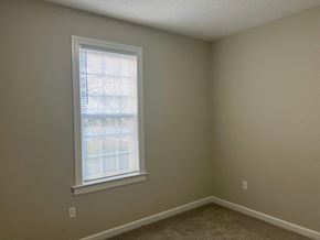 Wilson apartment for rent - A room with a window and a carpeted floor.