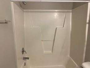 Wilson apartment for rent - A white bathroom with a toilet and a shower stall.