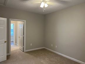 Wilson apartment for rent - A room with a ceiling fan and carpeted floor.