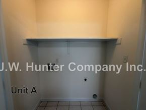 Wilson apartment for rent - A white wall with a shelf and a sign that says "J.W. Hunter Company Inc. Unit A".