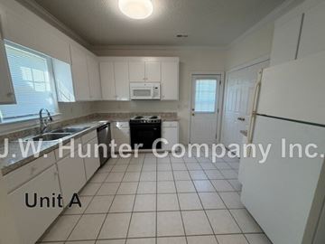 Wilson apartment for rent - A kitchen with white cabinets and a black dishwasher.