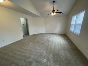 Wilson apartment for rent - A room with a ceiling fan and carpeted floor.