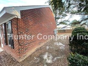 Wilson apartment for rent - A brick building with a sign that says Hunter Company Inc.