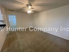 Wilson apartment for rent - A room with a ceiling fan and a window.