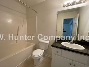 Wilson apartment for rent - A white toilet and sink in a bathroom.