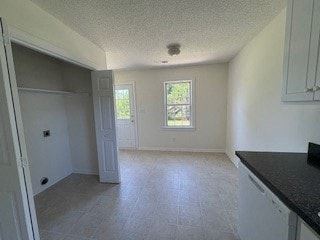 Wilson apartment for rent - A kitchen with a black counter top and white cabinets.
