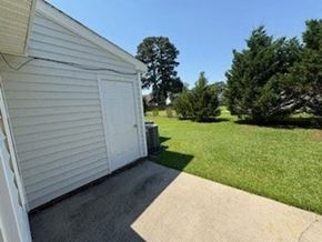 Wilson apartment for rent - A white garage door is on the left of a driveway.