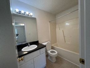 Wilson apartment for rent - A bathroom with a sink, toilet, and shower.