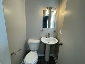 Wilson apartment for rent - A white toilet and sink in a small bathroom.