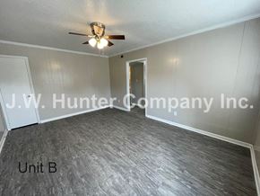 Wilson apartment for rent - A room with a ceiling fan and a door leading to another room.