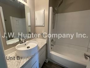 Wilson apartment for rent - A bathroom with a white sink and bathtub in a unit labeled B.