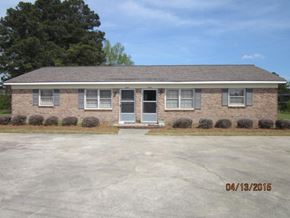Wilson apartment for rent - A house with a grey roof and a blue door.