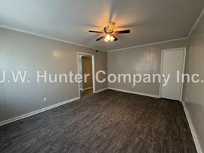 Wilson apartment for rent - A room with a ceiling fan and a wooden floor.