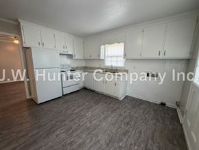Wilson apartment for rent - A room with white cabinets and a wooden floor.