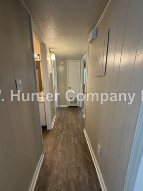 Wilson apartment for rent - A long, narrow hallway with a white door at the end.