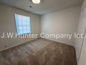 Wilson apartment for rent - A room with a carpeted floor and a window letting in natural light.