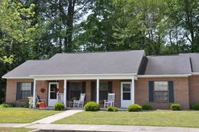 Wilson apartment for rent - A house with a front porch and a red flower on the door.