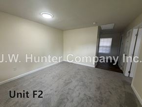 Wilson apartment for rent - A room with carpet flooring and a doorway leading to another room.