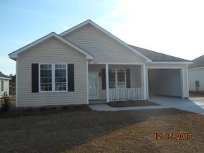 Wilson house for rent - a white house with a porch and a driveway