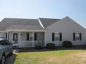 Wilson apartment for rent - a white house with a car parked in front of it