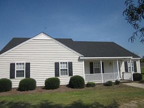 Wilson apartment for rent - a white house with a porch and a lawn