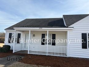 Wilson apartment for rent - A white house with a black roof and a sign that says J.W. Hunter Company, Inc.