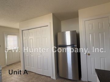 Wilson apartment for rent - A kitchen with a stainless steel refrigerator and white doors.