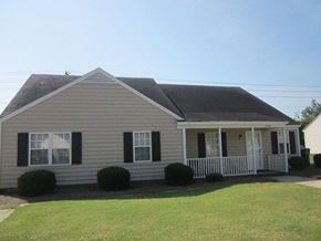 Wilson apartment for rent - a white house with a porch and a lawn
