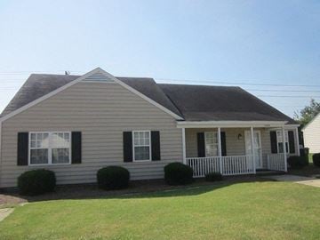 Wilson apartment for rent - a white house with a porch and a lawn