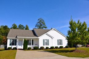 Raleigh apartment for rent - A white house with a grey roof and a driveway in front.
