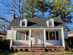 Wilson house for rent - a white house with green shutters and a front porch