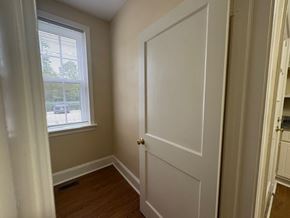 Wilson apartment for rent - A room with a white door and a window with blinds.