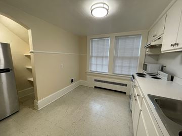 Wilson apartment for rent - A kitchen with a refrigerator, sink, and window.