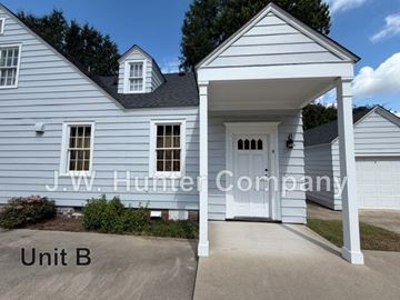 Wilson apartment for rent - A white house with a porch and a sign that says J.W. Hunter Company.